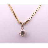 A diamond pendant on a 9 ct gold chain. Pendant 0.5 cm diameter, chain 40 cm long. 5.