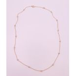 A cased 9 ct gold and seed pearl necklace. 44 cm long. 1.7 grammes total weight.