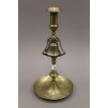 An antique brass and bell metal tavern candlestick. 33 cm high.
