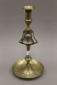 An antique brass and bell metal tavern candlestick. 33 cm high.