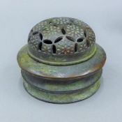 A Chinese bronze pierced topped censer. 12 cm diameter.
