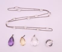 Three pendants (citrine, amethyst and rock crystal), a rock crystal brooch and a necklace.