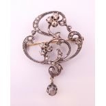 An unmarked silver and gold diamond brooch/pendant. 5 cm high.