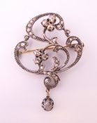 An unmarked silver and gold diamond brooch/pendant. 5 cm high.