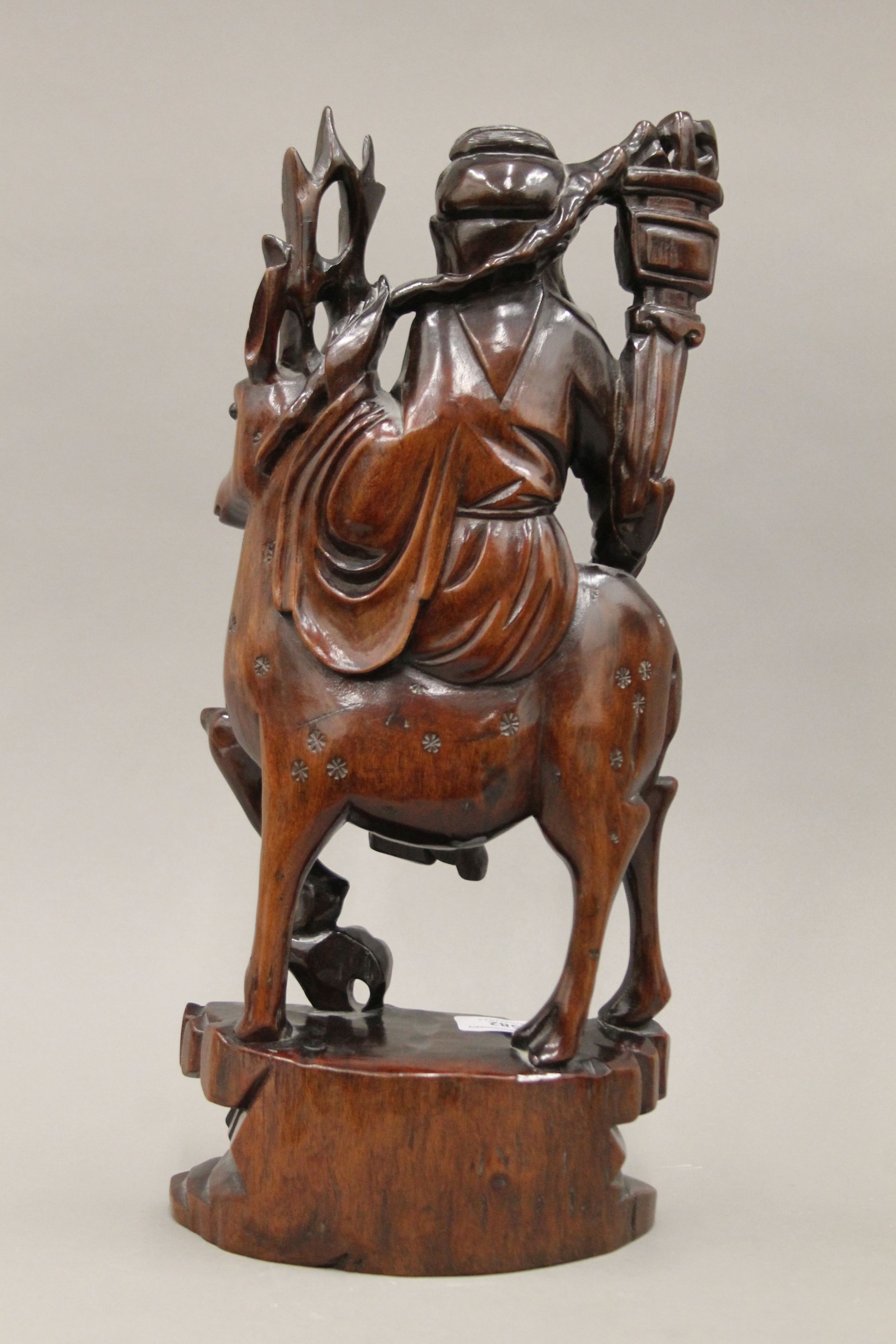 A pair of late 19th/early 20th century Chinese hardwood carvings depicting Guanyin riding a deer. - Image 4 of 4