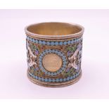 A Russian silver and enamel napkin ring. 4 cm high, 4.5 cm diameter. 50.9 grammes total weight.