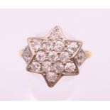 An 18 ct gold and diamond star form ring. Ring size V/W.