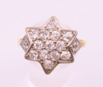 An 18 ct gold and diamond star form ring. Ring size V/W.