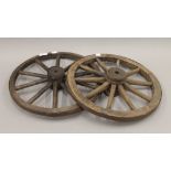 Two small antique iron mounted wooden wheels. 42 cm diameter.