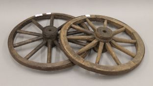 Two small antique iron mounted wooden wheels. 42 cm diameter.