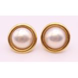 A pair of 9 ct gold and pearl earrings. 2 cm diameter.