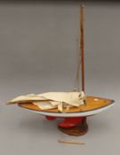 A vintage pond yacht on stand. 70 cm long x 91 cm high.