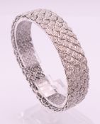 An Art Deco diamond set 18 ct white gold bracelet. 18.5 cm long. 38.9 grammes total weight.