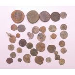 A collection of Roman coins and 16th century farthings.