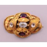 A Victorian unmarked 18 ct gold, aquamarine and garnet brooch, boxed. 3.5 cm long. 3.