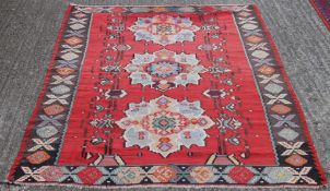 A Basra red ground runner (67 x 250 cm); together with a Kilim rug (155 x 215 cm).