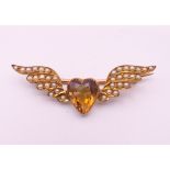 A 9 ct gold seed pearl and citrine sweetheart brooch. 4 cm long. 2.7 grammes total weight.