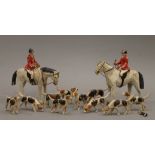 A Folk Art carved and painted wooden fox hunt set. The largest horse 14 cm high.