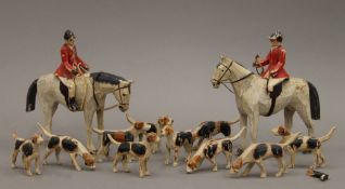 A Folk Art carved and painted wooden fox hunt set. The largest horse 14 cm high.