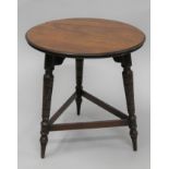 A Victorian walnut coffee table. 45 cm diameter.