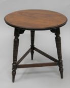 A Victorian walnut coffee table. 45 cm diameter.