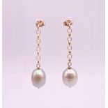 A pair of 9 ct gold and pearl drop earrings. 3.5 cm high overall, pearl 1 cm high.