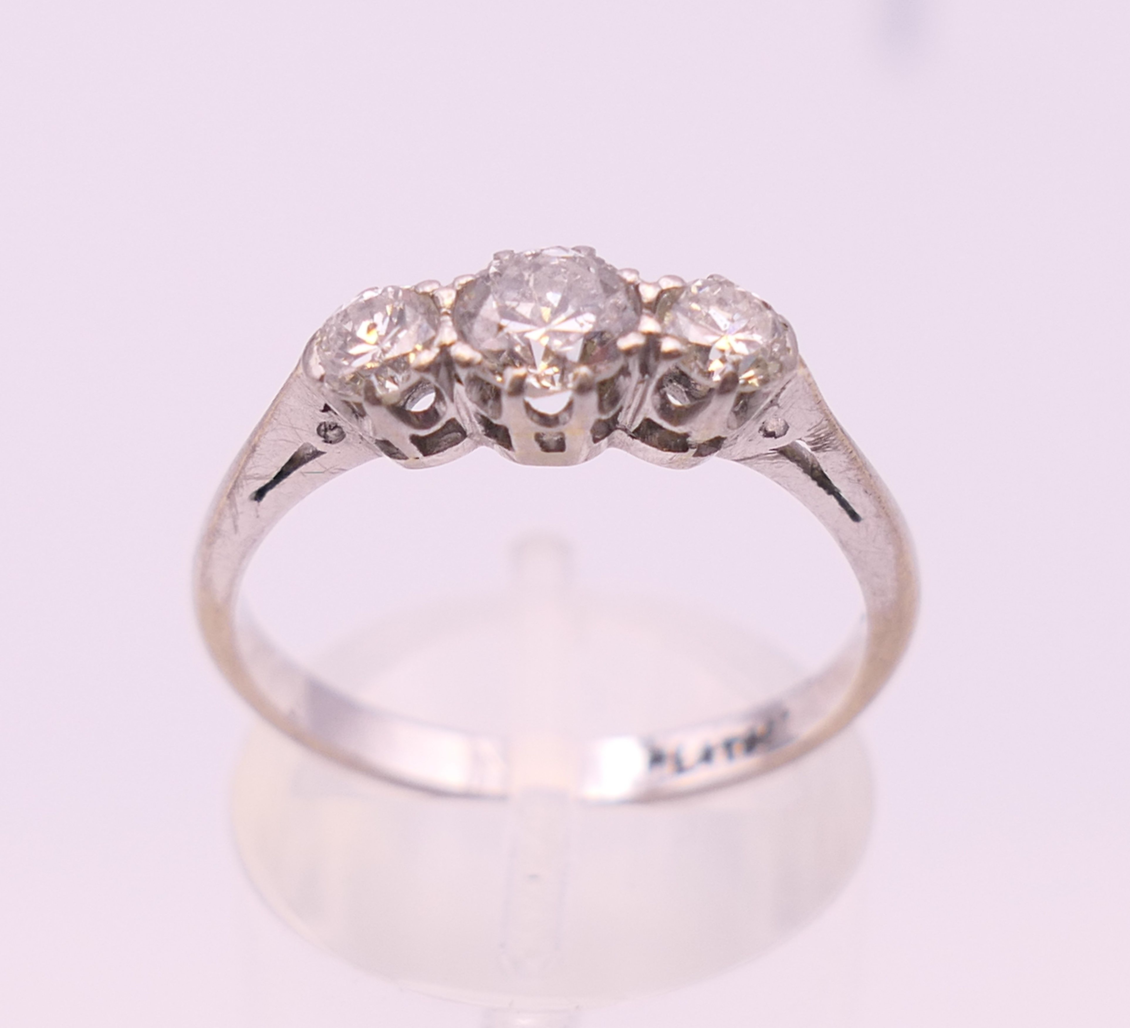 A platinum three stone diamond ring. Ring size P. - Image 3 of 7