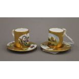 Two miniature Coalport porcelain cups and saucers, one decorated with country vignettes,