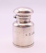 A small silver scent bottle in the form of a milk churn. 4.5 cm high.