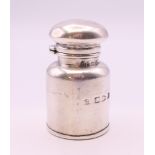 A small silver scent bottle in the form of a milk churn. 4.5 cm high.