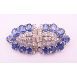 An unmarked Garrard and Co Ltd sapphire and diamond brooch, cased. 5 cm x 2 cm.