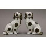 A pair of Victorian Staffordshire spaniels with green and copper lustre decoration. 14 cm high.