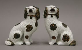 A pair of Victorian Staffordshire spaniels with green and copper lustre decoration. 14 cm high.
