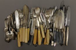 A quantity of silver and plated spoons and knives.