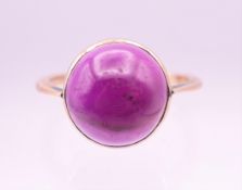 A 9 ct gold cabochon amethyst ring. Ring size N/O.