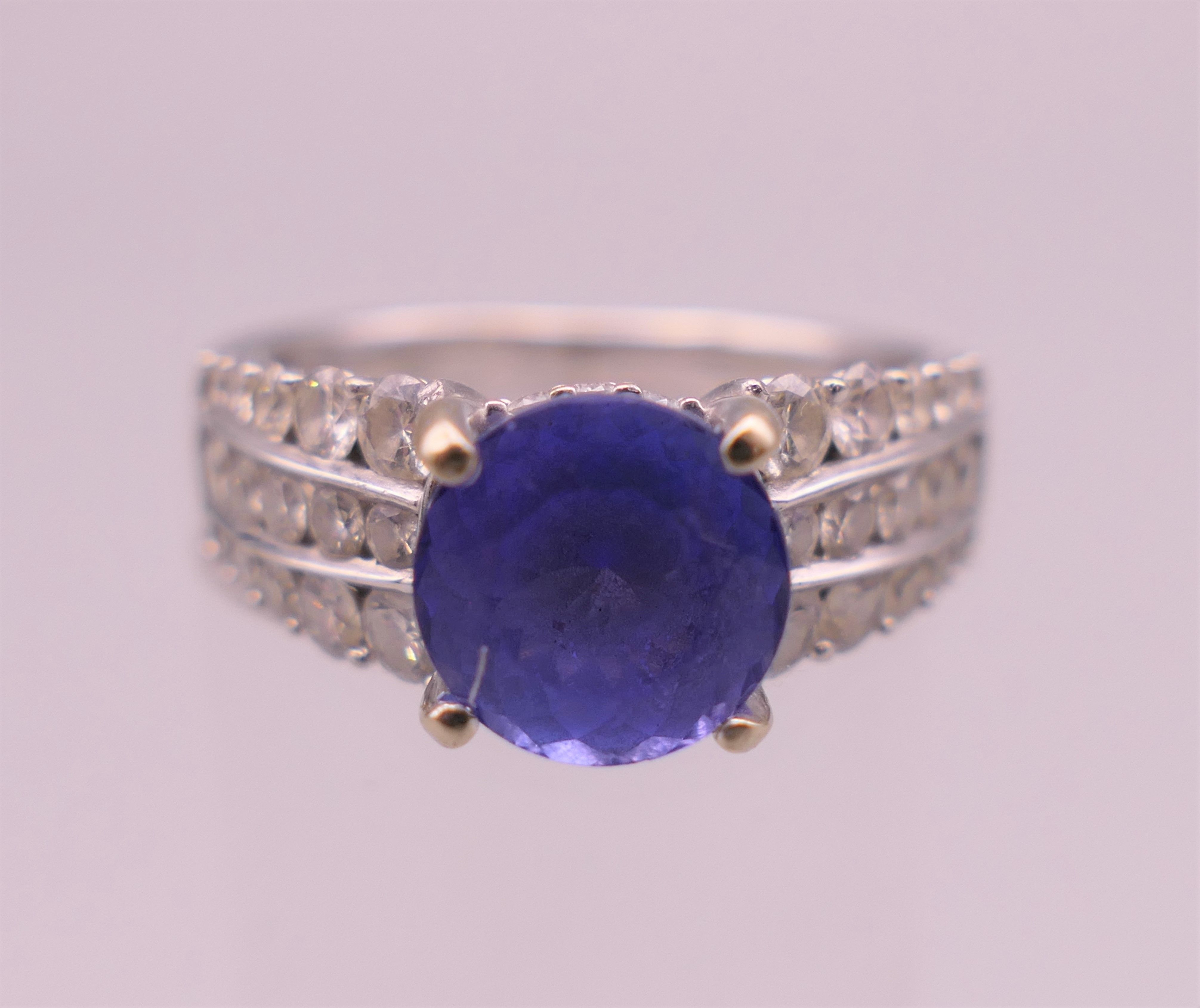 An 18 K white gold diamond and tanzanite ring;