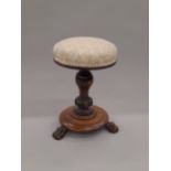 A Victorian upholstered rosewood revolving piano stool.