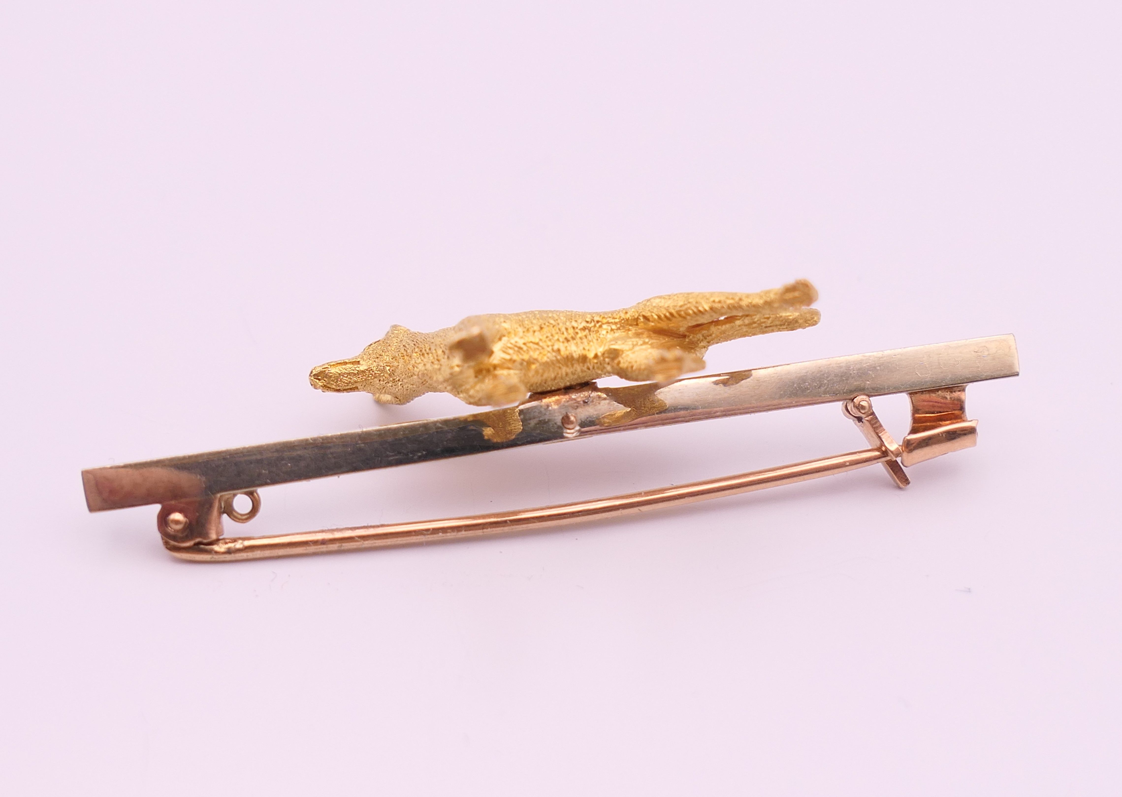 A 9 ct gold bar brooch, set with an unmarked 15 ct gold Alsatian. 5 cm long, dog 2.25 cm long. 7. - Image 2 of 9