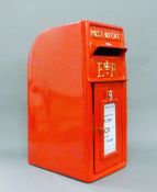 A red postbox. 60 cm high.