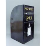A black postbox. 65 cm high.