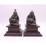 A pair of Chinese bronze figures on wooden bases. Tallest approximately 9.5 cm high including base.