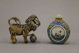 A Chinese glass scent bottle and a Chinese enamel decorated dog of fo. The former 6.5 cm high.