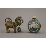 A Chinese glass scent bottle and a Chinese enamel decorated dog of fo. The former 6.5 cm high.