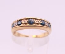 A 9 ct gold diamond and sapphire ring. Ring size L. 2 grammes total weight.