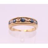 A 9 ct gold diamond and sapphire ring. Ring size L. 2 grammes total weight.