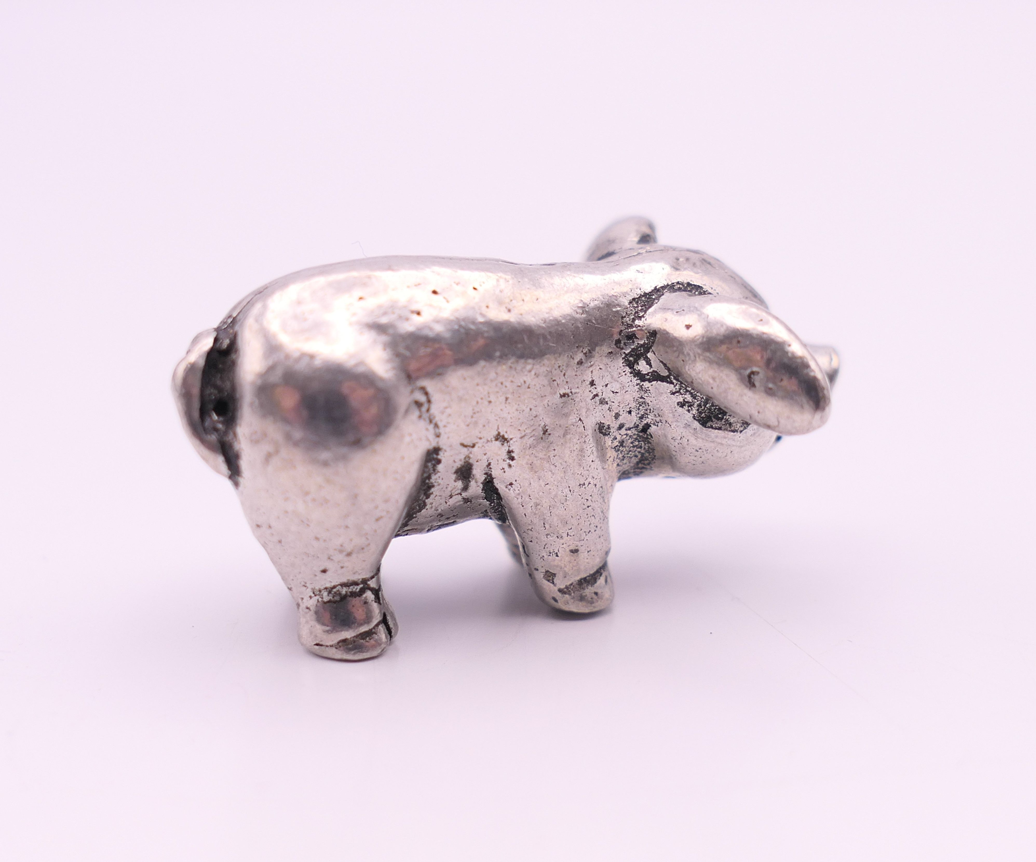 A small white metal model of a pig. 2.5 cm long. - Image 2 of 3