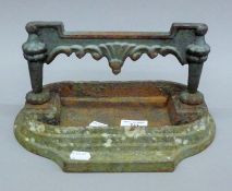 A Victorian cast iron boot scraper. 30 cm wide.