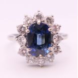 An 18 ct white gold sapphire and diamond ring. Ring size M/N.
