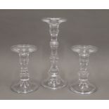 A set of three glass candlesticks. The largest 29.5 cm high.