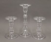 A set of three glass candlesticks. The largest 29.5 cm high.